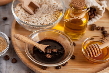 Concept of home beauty care and natural organic ingredients in cosmetology. Coffee, honey, oil, oat for gentle skin peeling and moisturizing. Health care lifestyle. Wooden background closeup