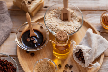 Concept of home beauty care and natural organic ingredients in cosmetology. Coffee, honey, oil, oat for gentle skin peeling and moisturizing. Health care lifestyle. Wooden background closeup