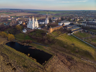 Fototapeta na wymiar Beautiful view of Zimnensky Svyatogorsky monastery from above. View of the domes and the Assumption Cathedral.