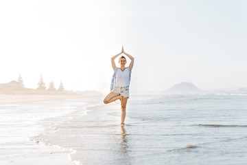 woman yoga on the beach