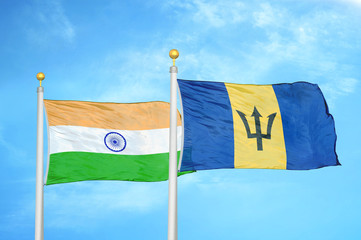 India and Barbados two flags on flagpoles and blue cloudy sky