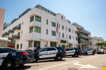 Police closing businesses in Miami Beach government order to slow spread of Coronavirus Covid 19