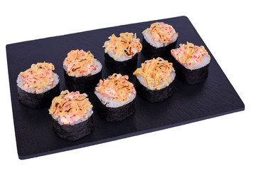 Traditional fresh japanese sushi rolls on black stone Kaji Double Syake Cheese on a white background. Roll ingredients: nori, rice, salmon, cream cheese, tobiko, sesame seeds, parmesan cheese.