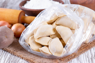 Frozen raw dumpling with potatoes in a plastic bag