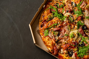 Appetizing pizza with smoked sausages bacon meat tomato cheese arugula