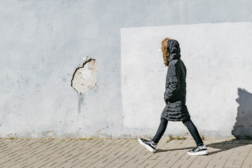 Young girl in a dark jacket on the street