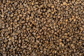 Roasted coffee beans background. Top view, overhead, flat lay.