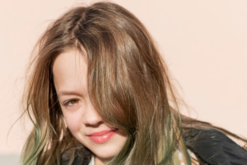 Young girl in a dark jacket on the street