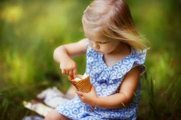 girl eating ice cream on the street and laughing, children's laughter, happy childhood