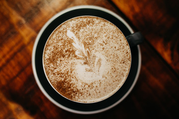 cup of coffee with sugar on wooden table