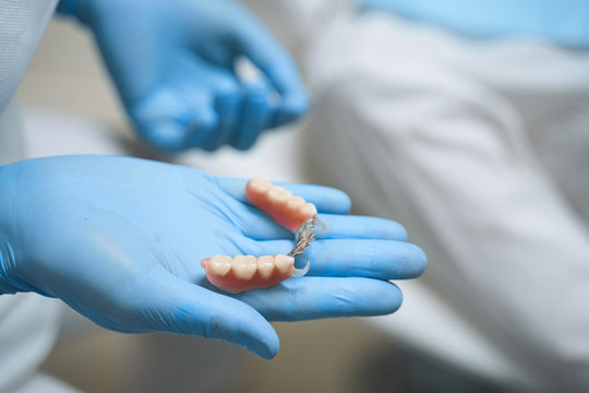 Dentist holding implants in hand stock photo