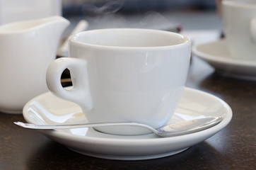 white cup of coffee with smoke