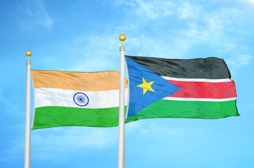 India and South Sudan two flags on flagpoles and blue cloudy sky