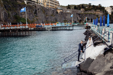 Happy wedding couple near the blue lake in Italy 