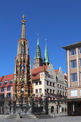 Nuremberg Beautiful Fountain in the foreground, behind it is the House of the Chamber of Commerce IHK and the towers of the St. Sebaldus Church Sebalduskirche. View from the main market Hauptmarkt.