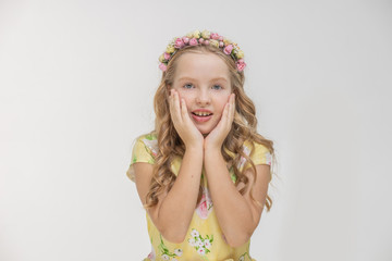 Close-up portrait of surprised pretty teen girl holding her head surprised and mouth open. Over white background