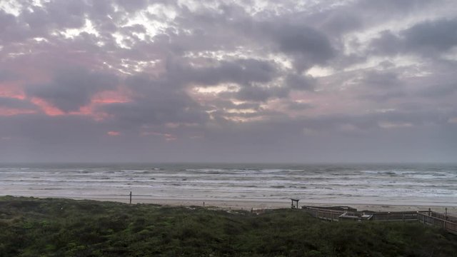 Time lapse of Early Sunrise Clouds Moving inland from Sea Over Texas Beach