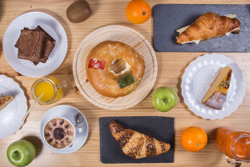 Top view on the table with pies, cakes, buns, pastries