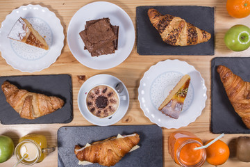 Top view on the table with pies, cakes, buns, pastries