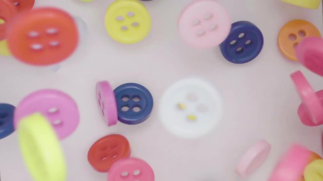 Buttons colorful couture falling. Many coloured buttons fall and run around. Color, fashion concept.