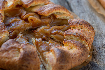 Cottage cheese dough galette with apples. .Curd dough galette with apples on wooden background. Apple crostata. Open pie. Homemade