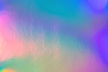 Abstract trendy rainbow holographic background in 80s style. Blurred texture in violet, pink and...