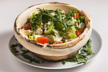 cesar salad served within bread