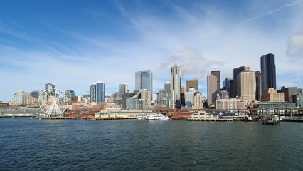 Fototapeta na wymiar Seattle, Washington - February 10, 2018 - Skyline of city of Seattle from Seattle - Bainbridge Island ferry on sunny winter afternoon.