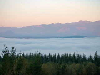 Fototapeta na wymiar Snoqualmie Valley Washington USA Foggy Cloud Cover Sunset Forest Mountain View