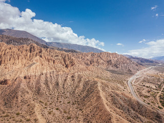 Andes Mountains, Cerro de los Siete Colores, Purmamarca Jujuy, Argentina colourful rock formation village and blue sky