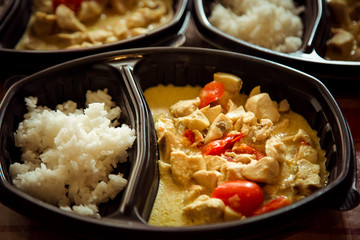 hot dish of meat and vegetables,with a side dish in a disposable container,for delivery of food at home