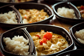hot dish of meat and vegetables,with a side dish in a disposable container,for delivery of food at home