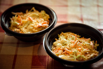 salad from fresh cabbage with cheese in a disposable container,for delivery of food at home