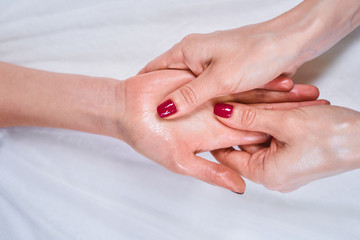 Tender female fingers massaging palm during session