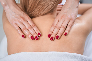 Young blonde woman enjoying her salon massage