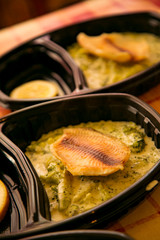 hot dish of meat and vegetables,with a side dish in a disposable container,for delivery of food at home