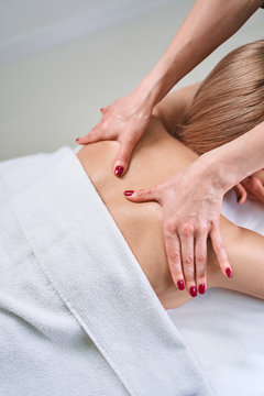 Professional practitioner doing massage for healthy back