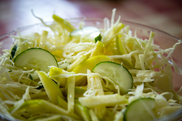 fresh cabbage salad with cucumbers,in a disposable container,for delivery of food at home