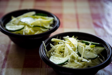 fresh cabbage salad with cucumbers,in a disposable container,for delivery of food at home