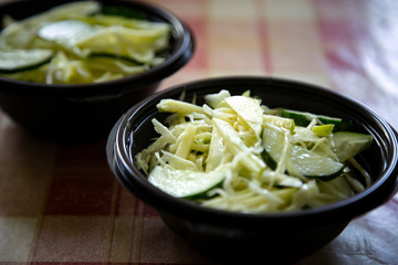 fresh cabbage salad with cucumbers,in a disposable container,for delivery of food at home