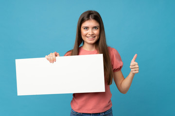 Young woman over isolated blue background holding an empty white placard for insert a concept