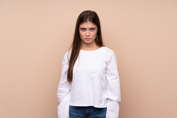 Obraz premium Young girl over isolated background with sad and depressed expression