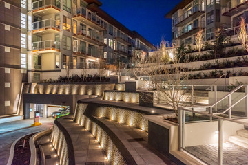 House building and city construction concept: night outdoor urban view of modern real estate homes.