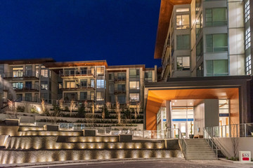 House building and city construction concept: night outdoor urban view of modern real estate homes.