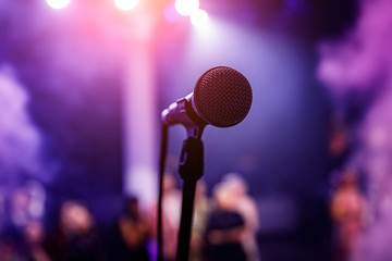 Microphone head on stage in a dark room.