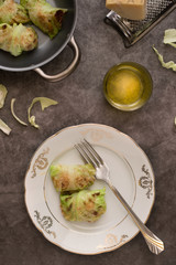 Vegan cabbage rolls on a white plate. Grey background