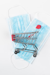 Medical mask in shop trolley on white background. Sale of medical masks. Coronavirus concept. 2019 nCoV.