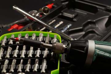 Naklejka premium Screwdriver bit set. Cordless with bit holder in the foreground.