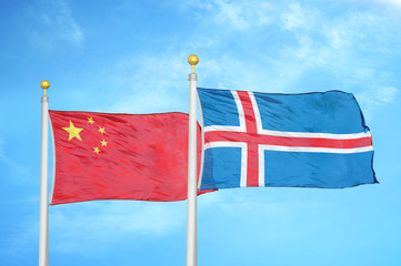China and Iceland two flags on flagpoles and blue cloudy sky