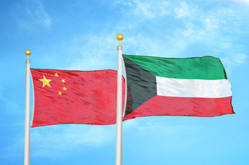 China and Kuwait two flags on flagpoles and blue cloudy sky